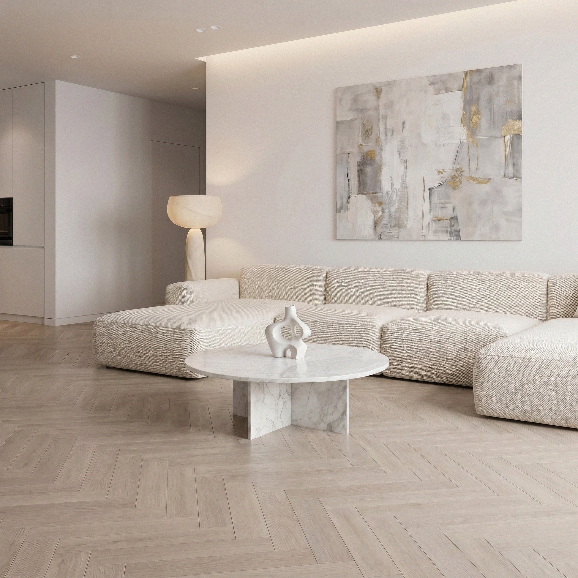 Mira Coffee Table from Marbeya Charm, a round coffee table in a living room with beige sofas and abstract paint on the wall